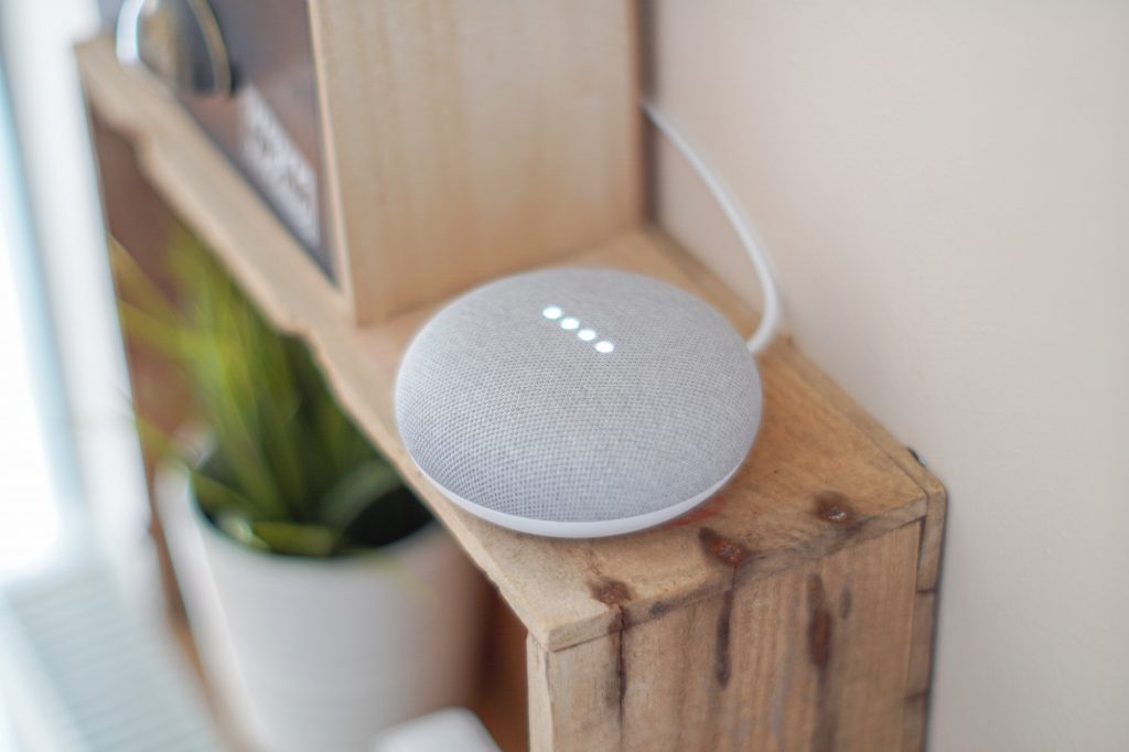 A Google Nest device placed on a shelf in a house