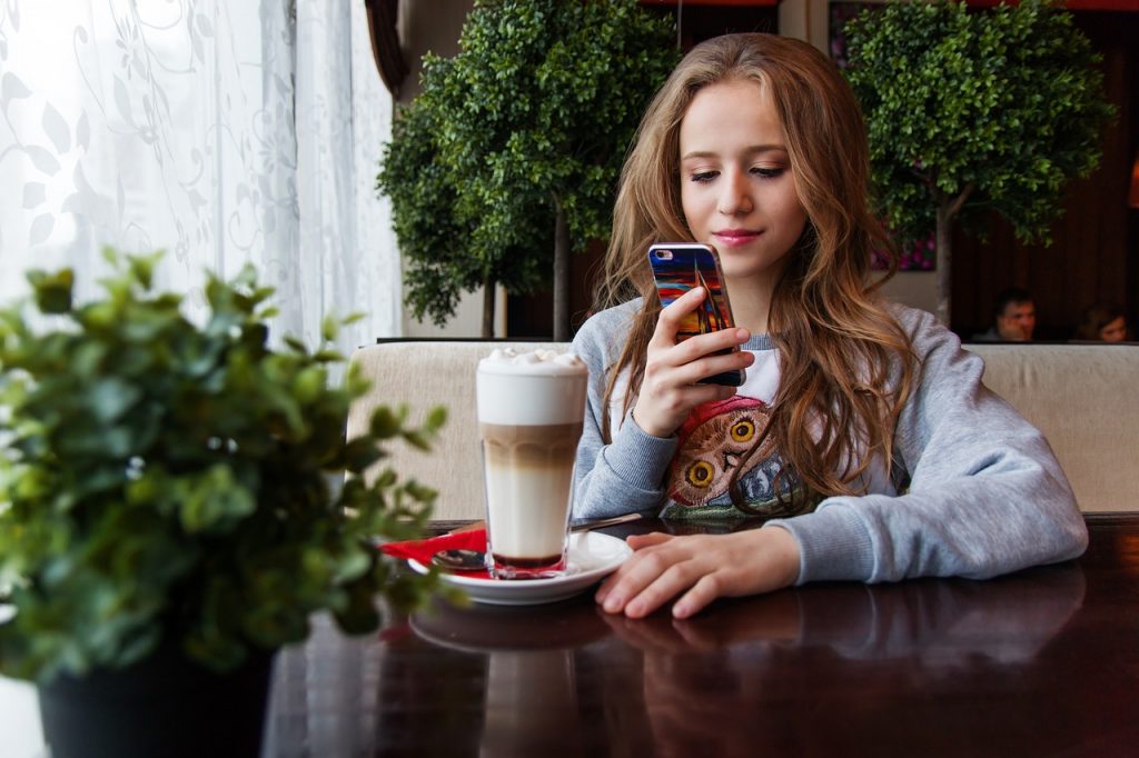 Girl with coffee on phone