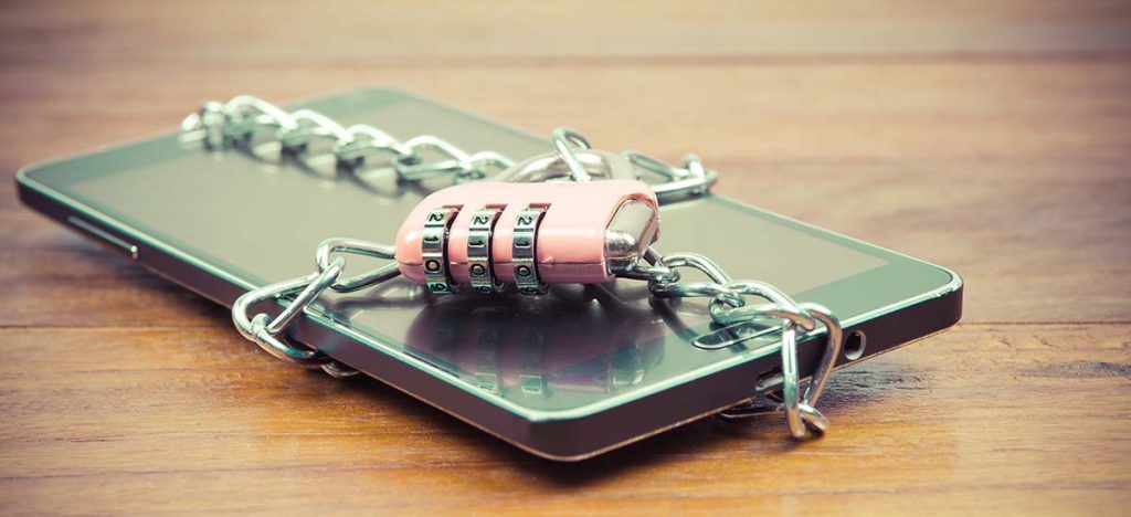 A phone wrapped in a chain with a padlock holding it together