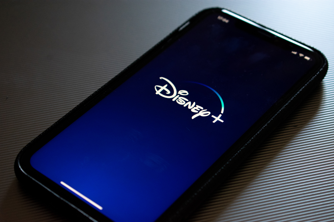 A mobile phone with Disney Plus loading on it