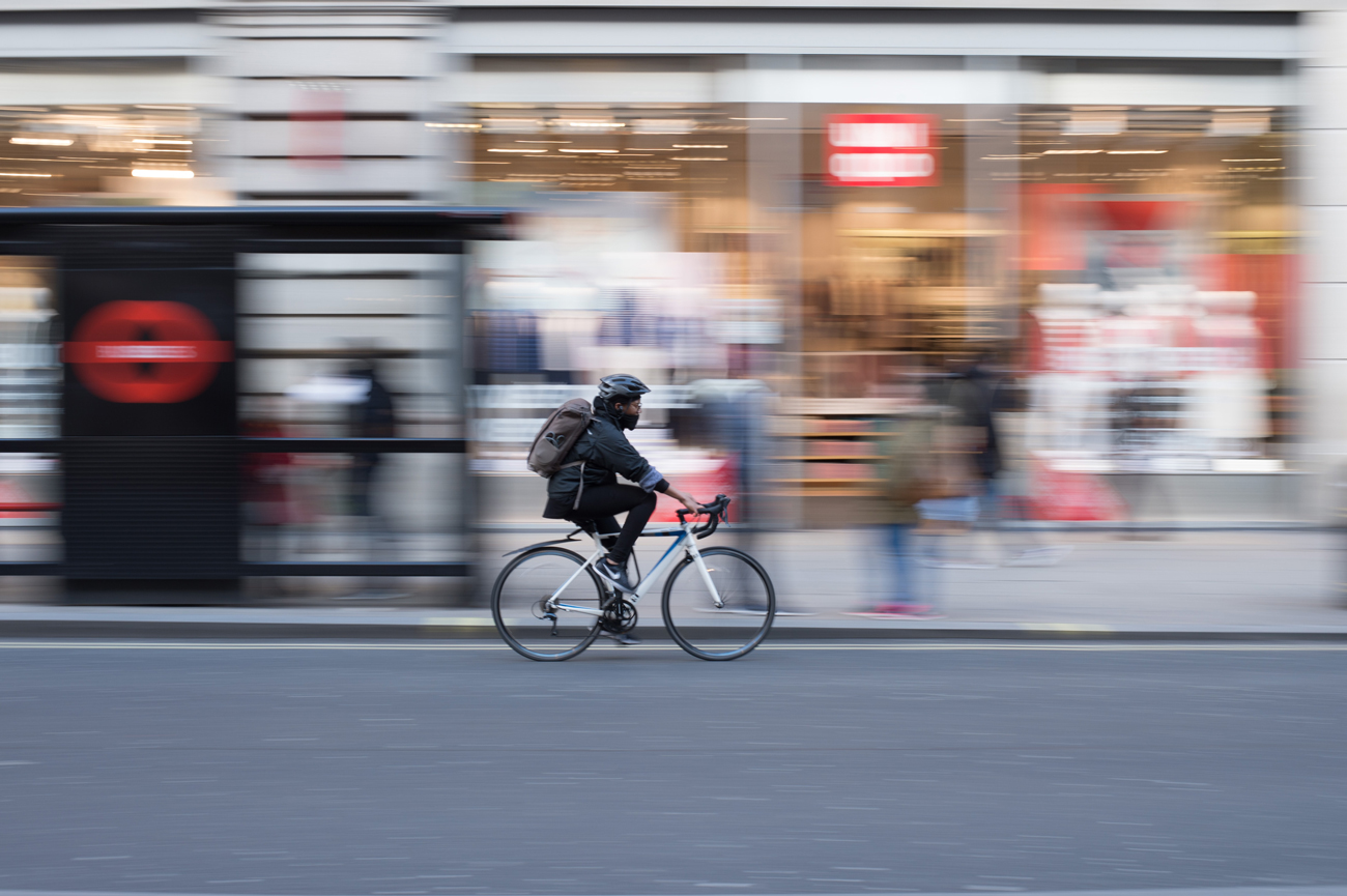 A cyclist commuting to work in a suit on a street in London